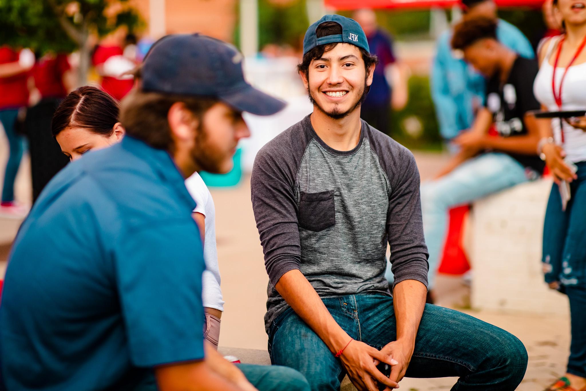 Student at Convocation smiling at the camera