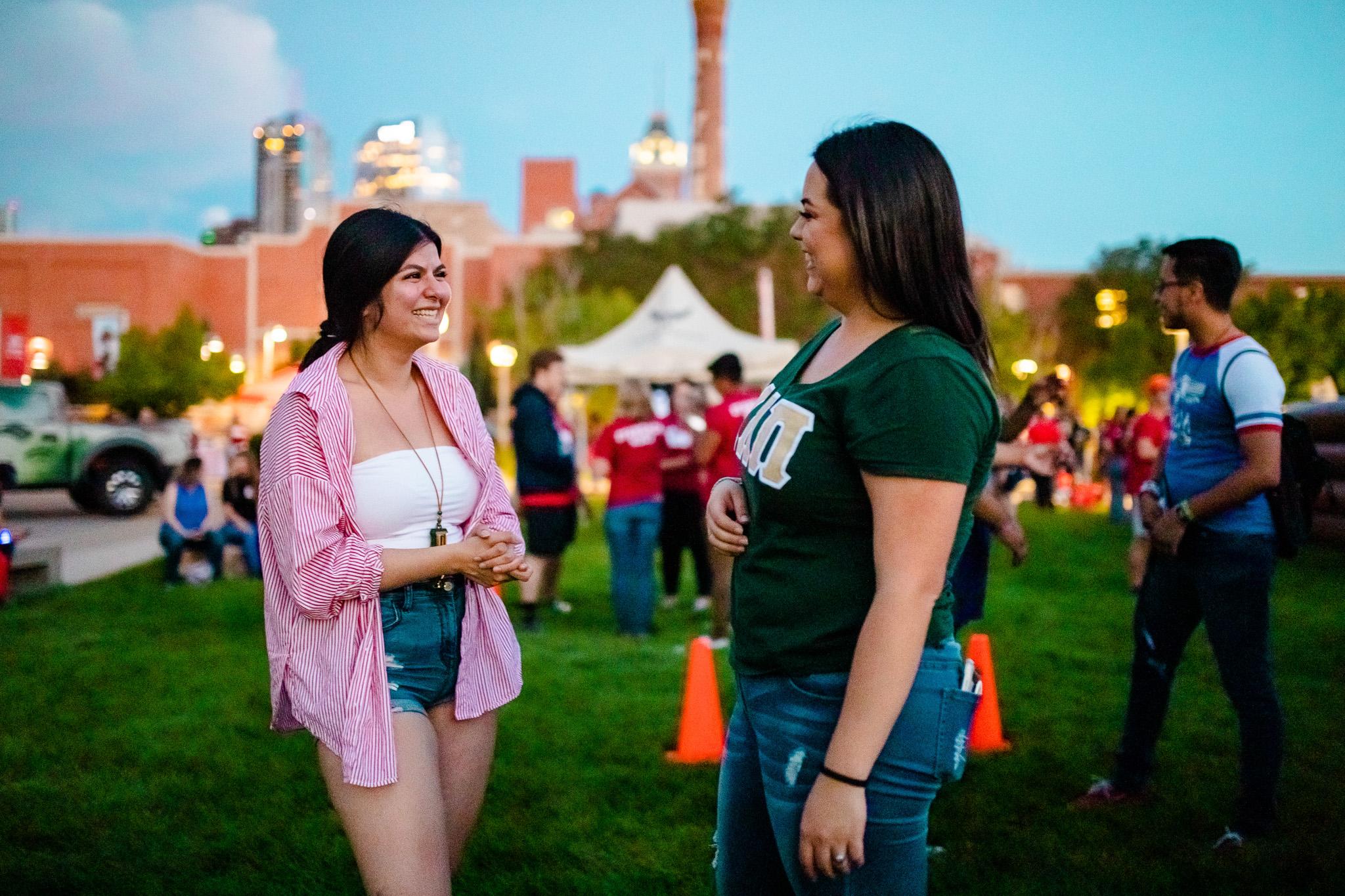 Sorority members smiling at each other during convocation